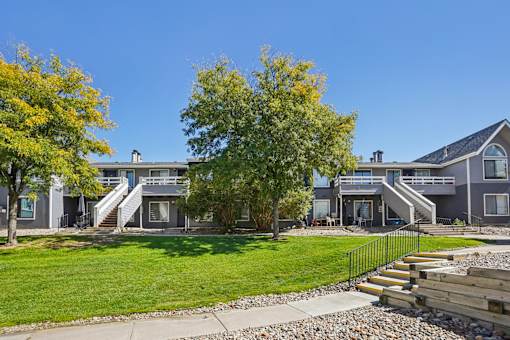 A row of houses with a clear blue sky above them. at Windmill Apartments, Colorado Springs, 80916