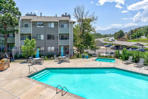 Swimming pool and a patio with chairs  at Union Heights Apartments, Colorado Springs, CO