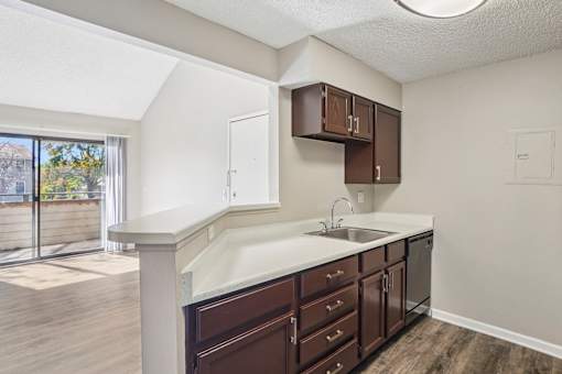 A kitchen with brown cabinets and a white countertop. at Deer Crest Apartments, Broomfield, CO, 80020