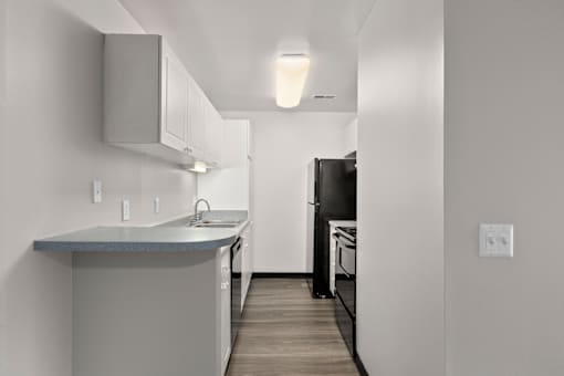 Kitchen with white cabinets and a black refrigerator at Creve Coeur, Creve Coeur, MO