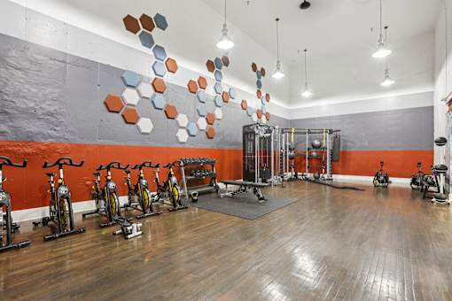 A gym with exercise bikes and weights. at Canopy Glen, Georgia, 30093