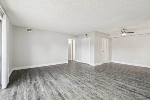 A room with a ceiling fan and wood flooring at Spyglass Creek, Denver, 80224