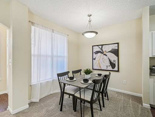 A dining room with a table set for four. at Cedar Springs Apartments, Raleigh, NC