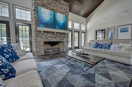 a living room with couches and a coffee table in front of a fireplace at St. Johns Forest Apartments, Florida, 32277
