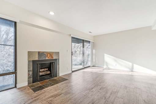 A large, empty room with a fireplace and wood flooring. at Cliffs at Canyon Ridge, Utah, 84401