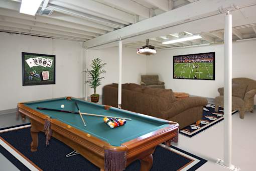 A pool table in a room with a TV showing a football game.