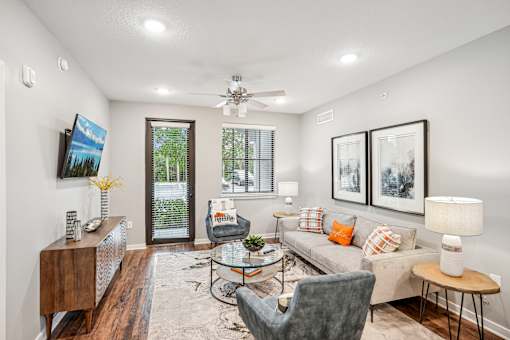 a living room with a couch and chairs and a ceiling fan at Edge75, Naples, Florida 34104