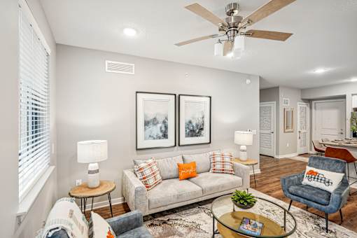 a living room with a couch and a ceiling fan at Edge75, Naples, Florida 34104