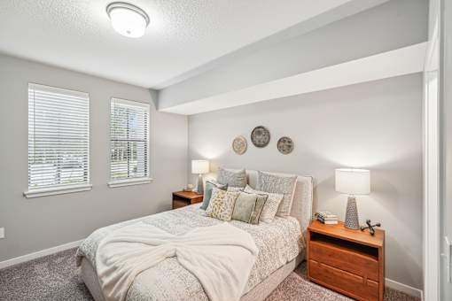 the master bedroom has plenty of windows and a comfy bed at Edge75, Naples, Florida 34104