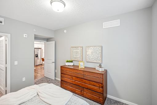 a bedroom with a dresser and a bed at Edge75, Naples, Florida 34104