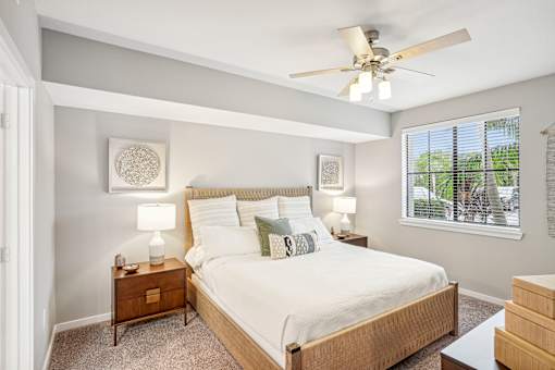 a bedroom with a large bed and a ceiling fan at Edge75, Naples, Florida 34104