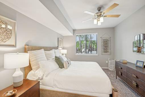 a bedroom with a large bed and a ceiling fan at Edge75, Naples, Florida 34104