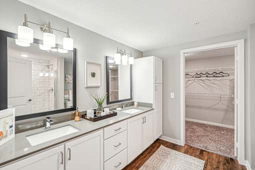 a white bathroom with two sinks and a mirror at Edge75, Naples, Florida 34104