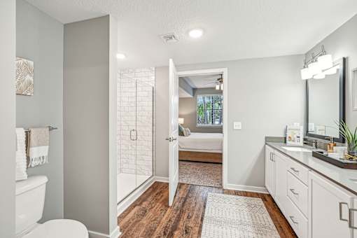 a bathroom with a shower and a sink and a mirror at Edge75, Naples, Florida 34104