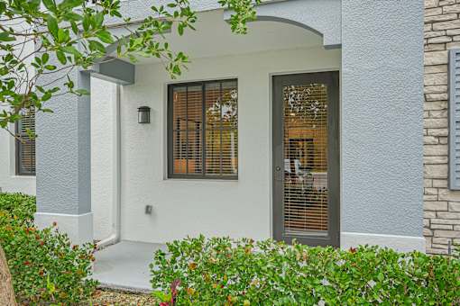 the front entrance of a house with a door and windows at Edge75, Naples, Florida 34104