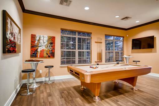 a game room with a pool table and a tv at Heritage at Stone Mountain, Northglenn, CO, 80233