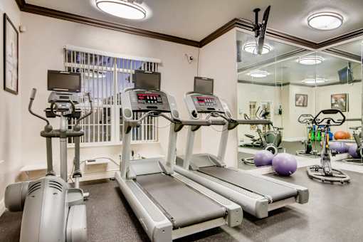 a gym with treadmills and other exercise equipment at Heritage at Stone Mountain, Northglenn, CO, 80233