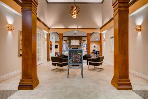 Lobby with a chalkboard sign in the middle at Heritage at Stone Mountain, Northglenn, CO, 80233