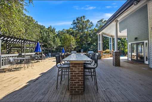 Large deck with a table and chairs on it at University Ridge Apartments, Durham, NC, 27707