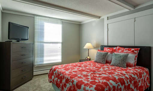 bed with orange at Glen at Burnsville, Burnsville Minnesota