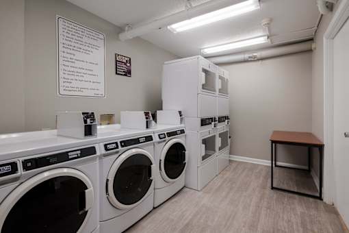 Laundry room with washes and dryers and a table at Esplanade at City Park, New Orleans, Louisiana