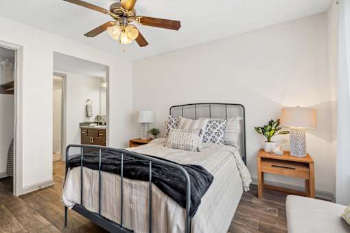 Bedroom with a bed and a ceiling fan at Lofts of Wilmington, Wilmington, NC