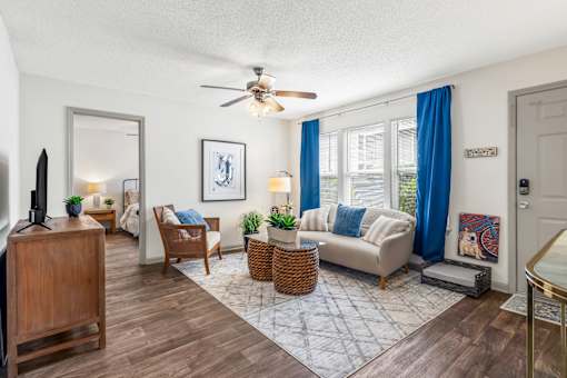 Living room with a couch and a ceiling fan at Lofts of Wilmington, Wilmington, NC