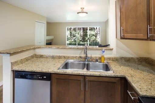 A kitchen with a sink and a dishwasher at Arcadia Townhomes, Federal Way, WA