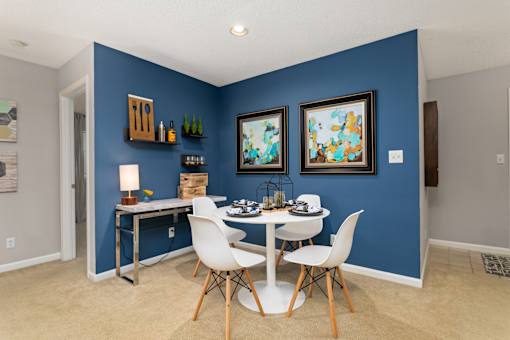 Dining room with blue walls and a white table and chairs at University Ridge Apartments, Durham, NC, 27707