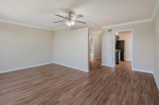 Empty living room with ceiling fan at Esplanade at City Park, New Orleans, Louisiana