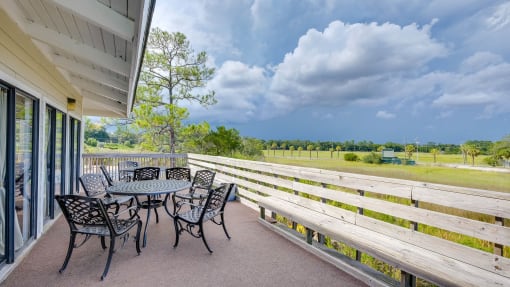 Outdoor Seating with Green Views at River Crossing Apartments, Thunderbolt, GA