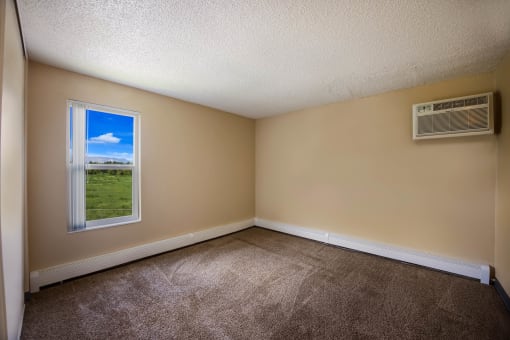 an empty room with a window and an air conditioner at Broadmoor Springs, Colorado Springs, CO, 80906