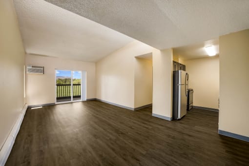 an open living room with a balcony and refrigerator at Broadmoor Springs, Colorado Springs, CO, 80906