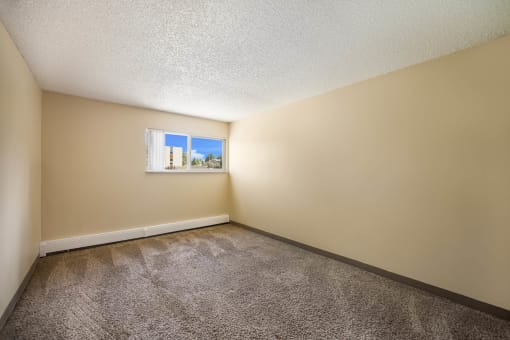 an empty bedroom with a small window at Broadmoor Springs, Colorado Springs, CO, 80906