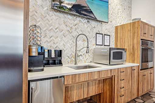 a kitchen with a sink and a microwave at Riverwalk Apartments, Lawrence, MA