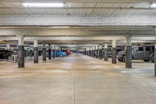 an empty parking garage with cars parked in it at Riverwalk Apartments, Lawrence, MA