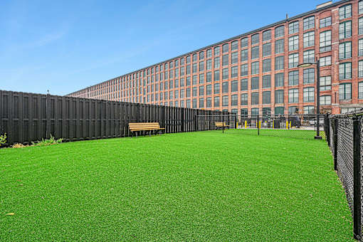 a green lawn in front of a large building at Riverwalk Apartments, Lawrence, MA