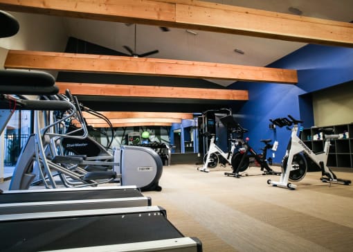 a gym with cardio equipment and weights on the floor at Spyglass Creek, Denver, 80224
