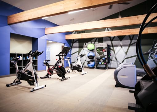 a gym with cardio equipment and weights on the floor at Spyglass Creek, Denver, 80224