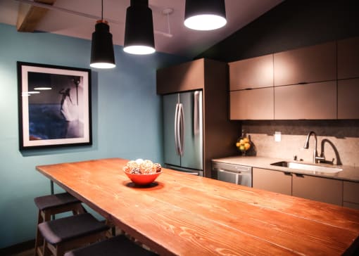 a kitchen with a wooden table with a bowl of popcorn on it at Spyglass Creek, Denver, 80224