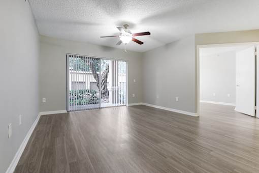 an empty living room with a ceiling fan and a window at Pembroke Pines Landings, Florida
