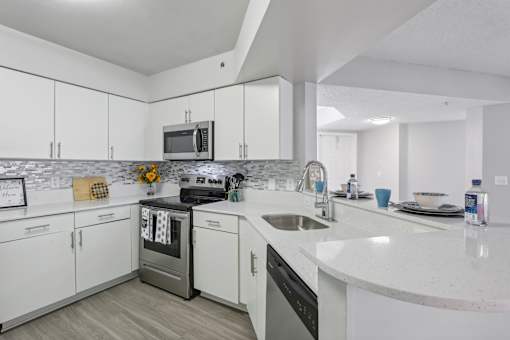 a kitchen with white cabinets and stainless steel appliances at Pembroke Pines Landings, Pembroke Pines