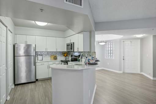 a kitchen with white cabinets and a stainless steel refrigerator at Pembroke Pines Landings, Florida, 33025
