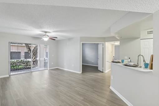 an open living room and kitchen with a sliding glass door to a patio at Pembroke Pines Landings, Pembroke Pines, Florida, 33025