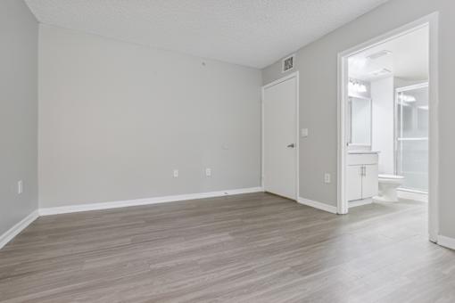 an empty living room with white walls and wood flooring at Pembroke Pines Landings, Pembroke Pines