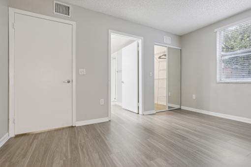 the living room of an apartment with white walls and wood floors at Pembroke Pines Landings, Pembroke Pines, FL 33025