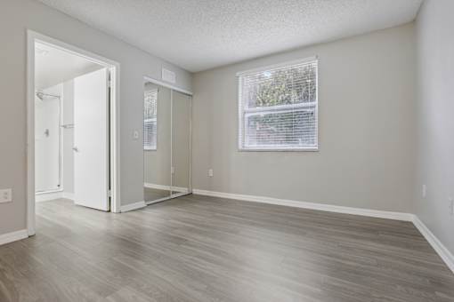 an empty living room with wood floors and a window at Pembroke Pines Landings, Florida