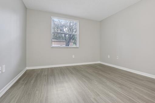 an empty room with wood floors and a window at Pembroke Pines Landings, Florida