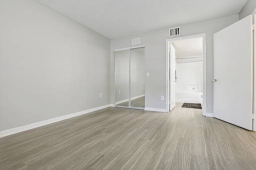 an empty living room with white walls and wood flooring at Pembroke Pines Landings, Pembroke Pines