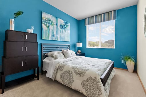a bedroom with a bed and a dresser